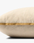 The Loloi Rugs PJBR0001 Natural GO Pillow, featuring beige and white cotton stripes, yellow edging, and a convenient zipper, is shown in close-up side view against a plain white background.