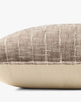 A close-up side view of the Loloi Rugs PLL0183 Brown/Ivory Pillow 16x26, featuring textured brown and ivory striped cotton on top, smooth solid beige on the bottom, and a subtle Loloi logo tag.