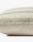 A close-up side view of the Loloi Rugs PAL0040 Zephyr Ivory throw pillow, featuring soft polyester fabric with subtle horizontal light brown and cream stripes, a plush knife edge, and set against a plain white background.
