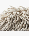 A close-up of the PLL0103 Silver Pillow 13x35 by Loloi Rugs, resting on a white background, showcases its durable cotton fibers and elegant, twisted texture.