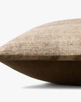A close-up side view of the PLL0143 Brown Pillow by Loloi Rugs, featuring textured beige cotton fabric on top and smooth dark brown polyester on the bottom, set against a plain white background.