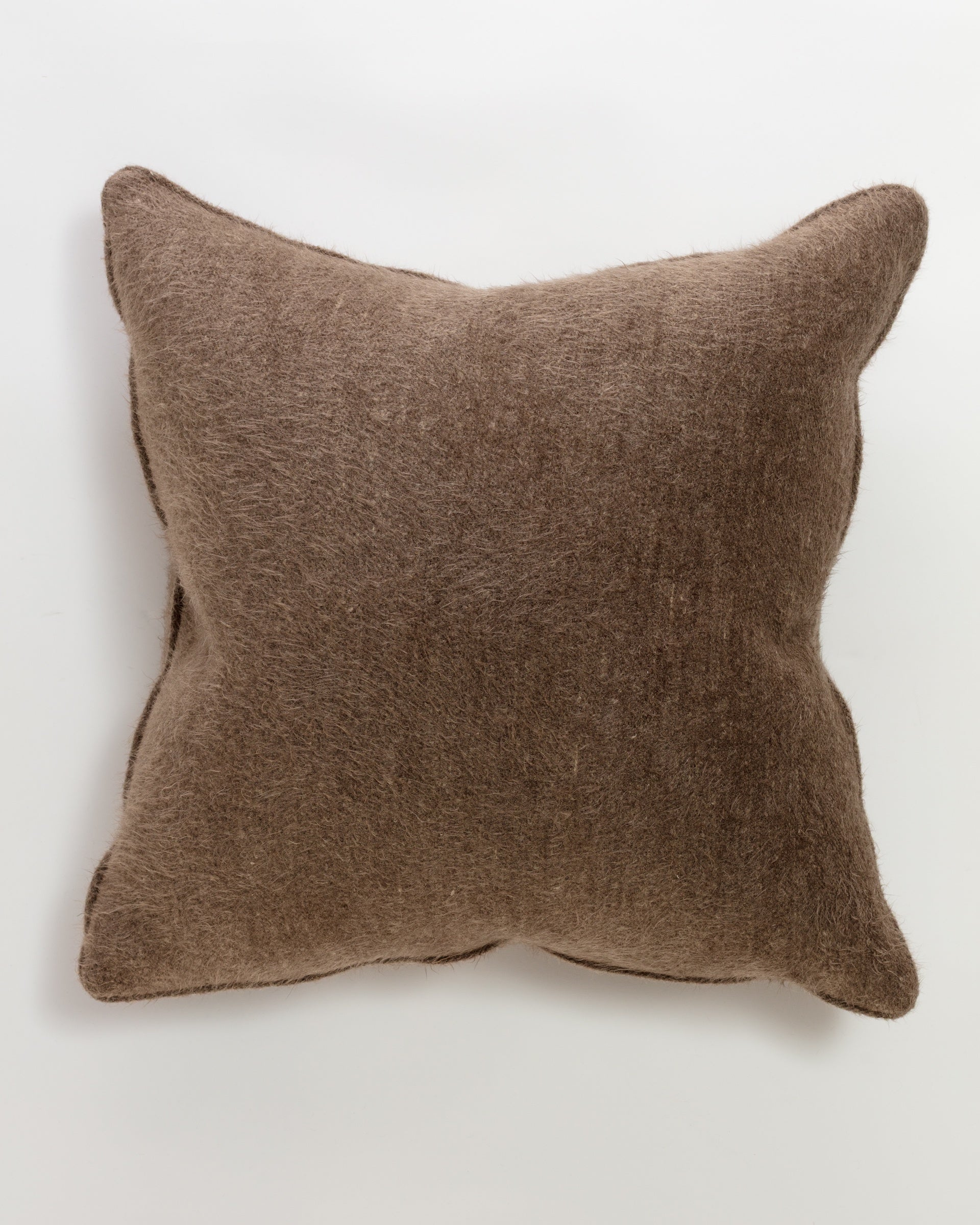 The Cuddles Coco 26 euro pillow by Massoud is square, brown, and fuzzy, displayed on a plain white background. Its soft, plush texture and slightly pointed corners give it a cozy, luxurious appearance.