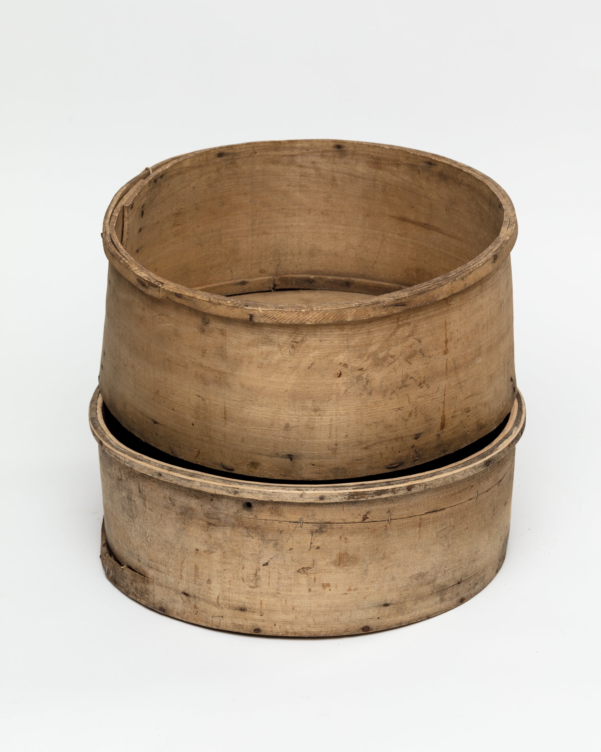 Two Indus Design Imports CHEESE MOLD BUCKET 35 nested together, viewed on a plain white background in a Scottsdale Arizona bungalow. The wooden containers are circular with visible aging and patina.