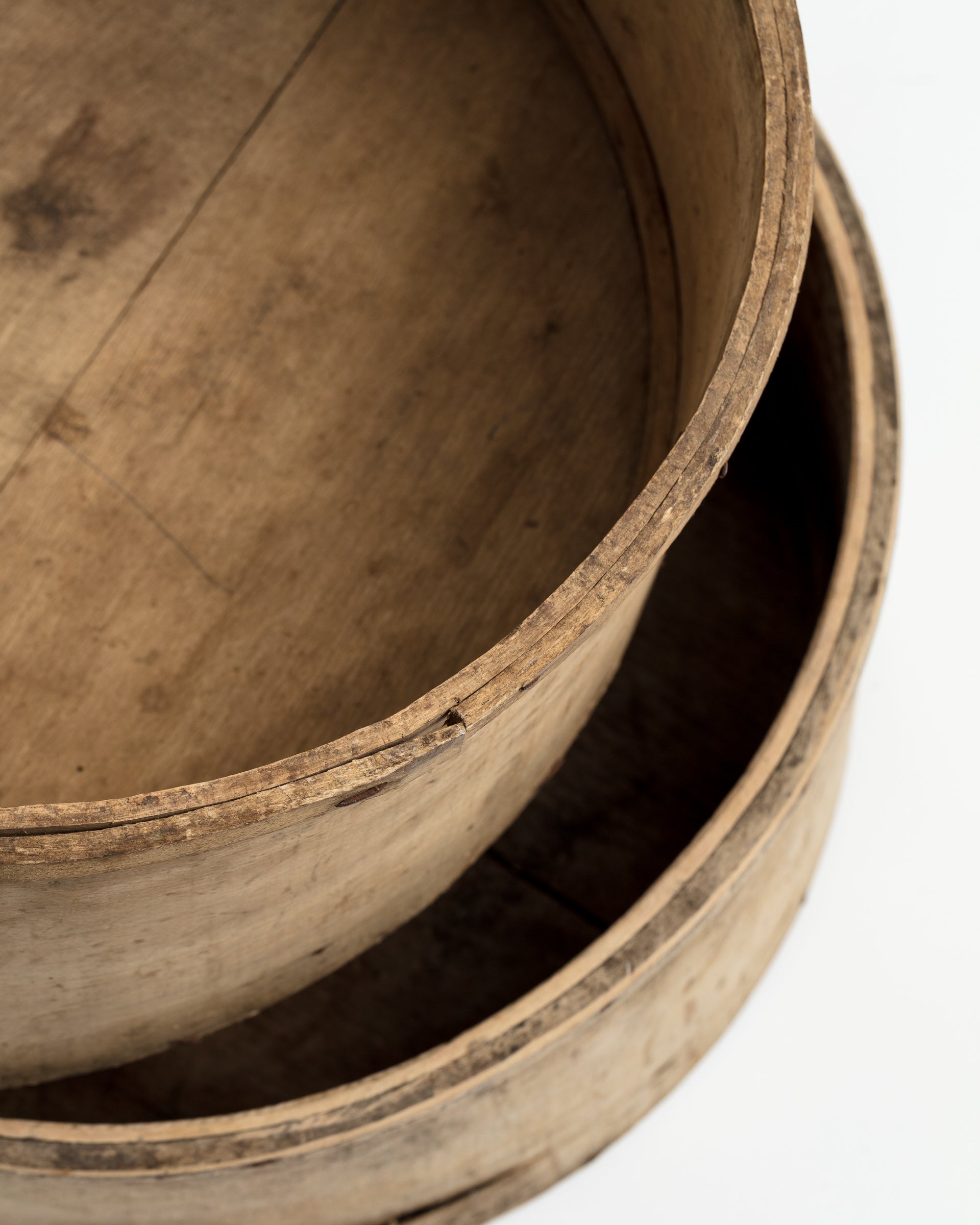 Close-up of two stacked CHEESE MOLD BUCKET 35 from an Indus Design Imports Scottsdale Arizona bungalow, showing aged texture and natural grain, isolated on a white background.