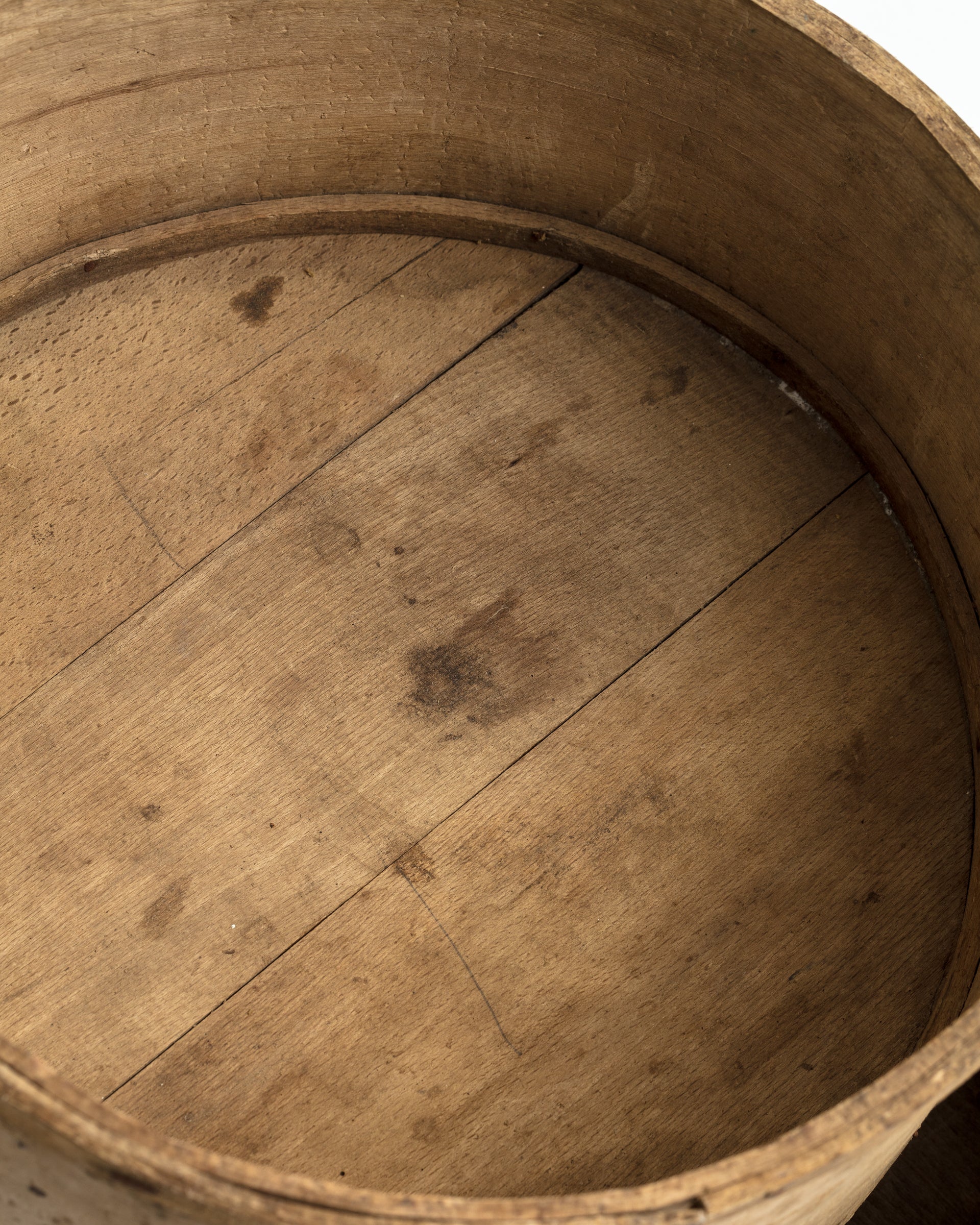 Close-up view of the interior of an old wooden barrel showing worn and stained wooden planks in a Scottsdale Arizona bungalow.