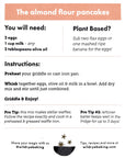 The Wild Rye Almond Flour Pancake Mix recipe card lists ingredients, a plant-based substitute, step-by-step instructions, two pro tips, and wildrybaking.com contact info—all for nutritious, kid-approved pancakes.
