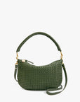 The Clare Vivier Petit Moyen Messenger S25 is a green handwoven leather mini bag with a curved top handle, detachable crossbody straps, gold-tone hardware, and a small round charm by the zipper.