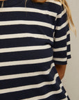 Close-up of a striped beauty wearing the Perfectwhitetee Rhett SS Tee Dress in navy blue and white. The face is not visible, and long, light brown hair falls over the shoulder.