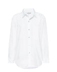 The Ruth Oversized Shirt by AMO Denim is a classic white cotton poplin shirt featuring long sleeves, a collar, and front pocket, shown against a plain white background.