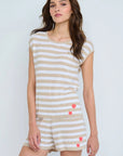 A woman wearing the Lisa Todd Summer Lovin Sweater stands against a light background, looking at the camera with a neutral expression.