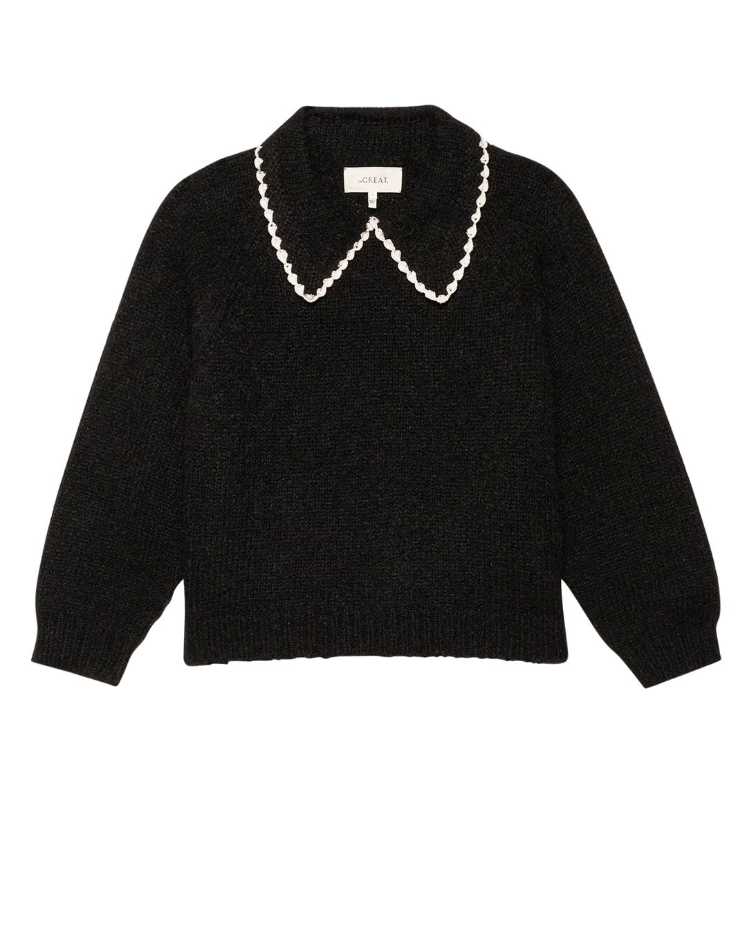 The Crochet Collar Pullover by The Great Inc. is a black long-sleeve sweater with a plush yarn, crochet collar, and scalloped white trim, shown laid flat on a white background.