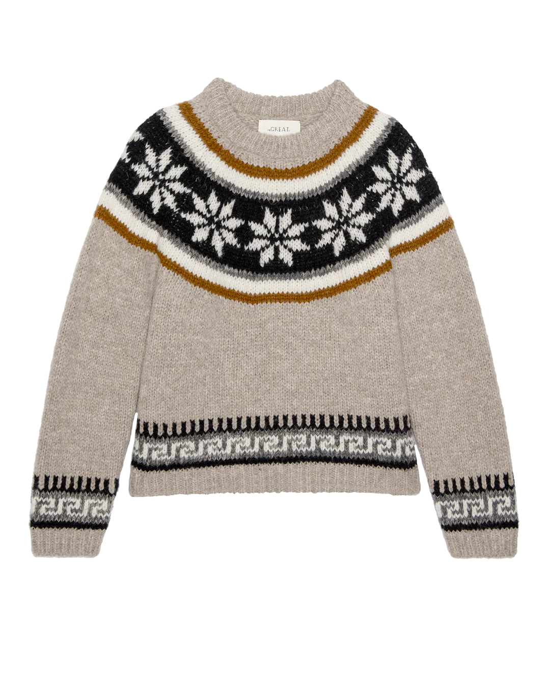 The Snowflake Fairisle Pullover by The Great Inc. is a beige wool sweater with a round neck, featuring black, white, and gold snowflake patterns and geometric designs—perfect winter knitwear for chilly days.