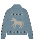 The Stable Lodge Cardigan by The Great Inc. is a light blue knit with a bold white western horse motif on the back, framed by black, white, and gray diamond patterns along the sleeves and back.