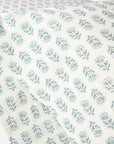 Close-up of Coyuchi Inc's Org Percale Pillowcase Dew Chrysanthemum S/2 Queen, made from 100% organic cotton with soft white fabric and evenly spaced, delicate light blue floral prints inspired by nature.