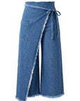 Le Superbe's Its a Wrap Pant features wide-leg, cropped denim culotte style with a wrap design, frayed edges, side tie closure, and a left thigh patch pocket.