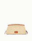The Maude Convertible Clutch by Staud features woven straw raffia with brown leather trim and a small front leather patch, shown against a plain white background.