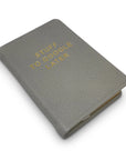 A compact gray goatskin leather Mini Notebook by Kempton & Co. features a textured cover with gold embossed "STUFF TO GOOGLE LATER" and is shown against a white background.