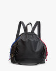 The Clare Vivier Sac Tout Backpack is made of black recycled nylon with a drawstring closure, two adjustable straps, and blue and red cords on each side, shown against a plain white background.
