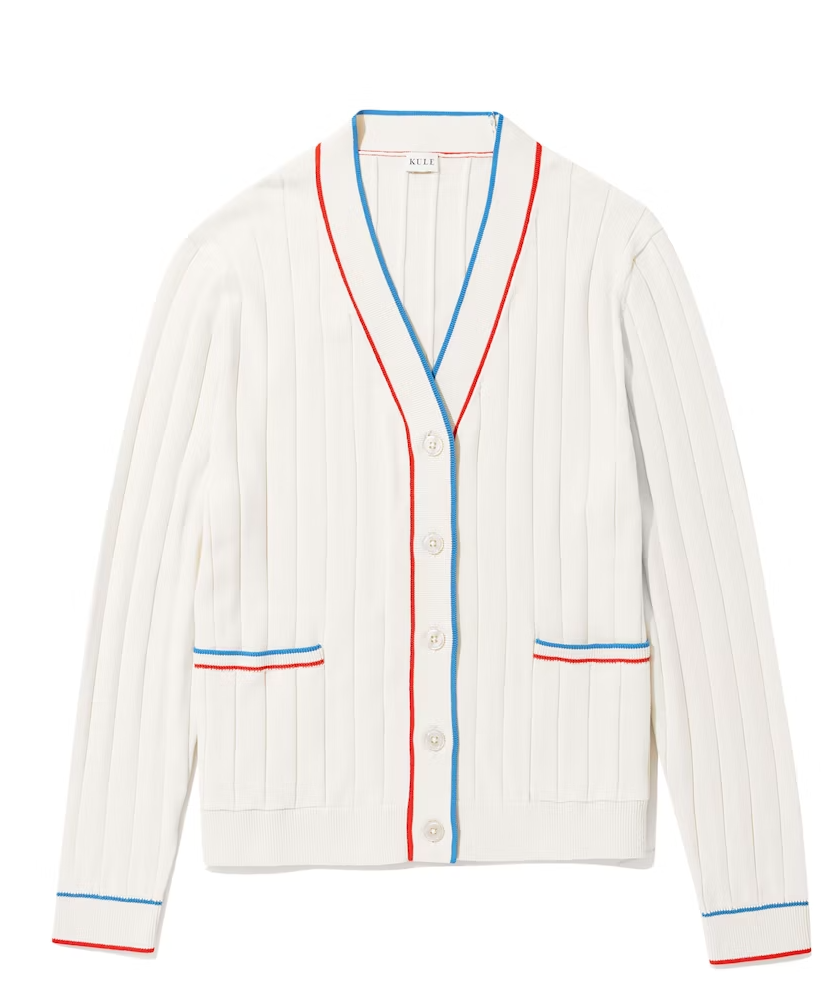 White baseball-style jacket with blue and red trim, featuring a V-neck collar, button front, and two horizontal stripe pockets inspired by Scottsdale Arizona designs from Kule's THE DEDE CREAM collection.