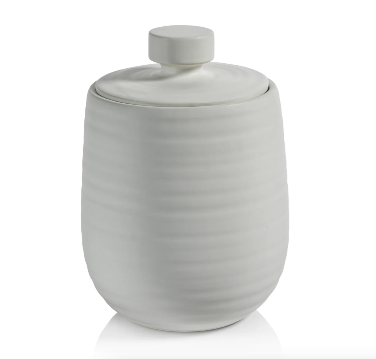 A white ceramic Arpège Lidded Jar - Medium with a smooth, rounded body featuring vertical ridges and a flat, round lid with a simple knob handle, isolated on a white background, embodying Zodax style.
