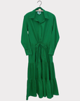 A bright green mid-length dress with long sleeves and a cotton drawstring waist, displayed on a hanger against a plain white background.