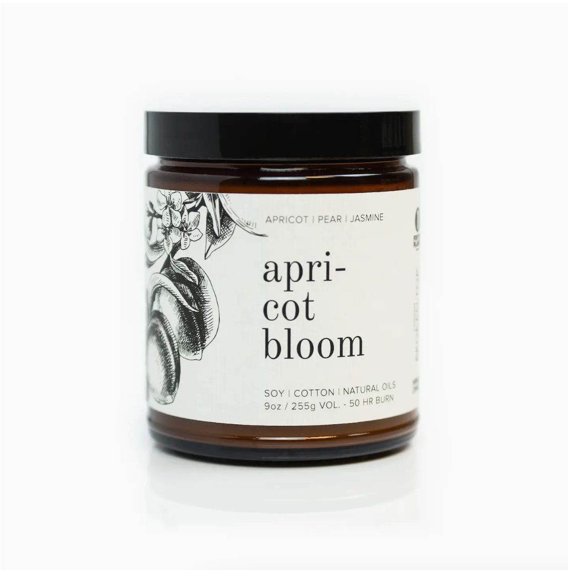 A Faire soy candle in a clear glass jar with a label that reads "Apricot Bloom" and includes illustrations of fruit and flowers. The label mentions cotton, natural oils, and a 50-hour burn time.