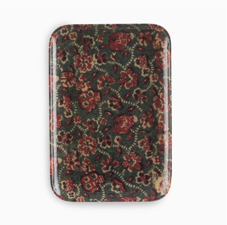 A vintage floral-patterned metal tin with a hinge, featuring a design of red and beige flowers and green foliage on a Scottsdale Arizona-inspired dark background by Faire.