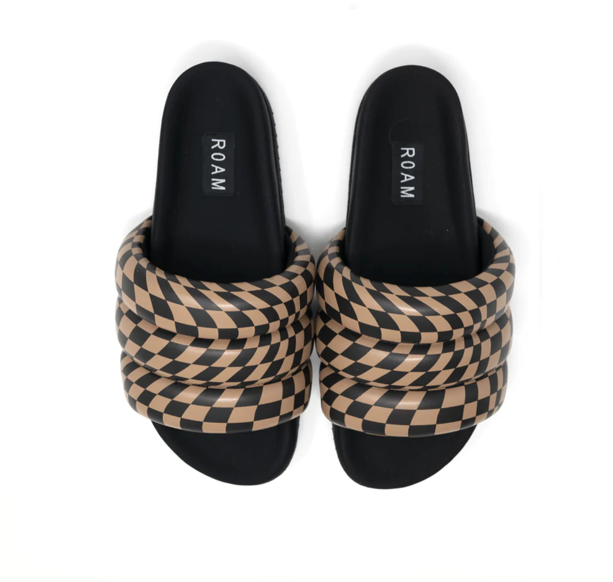 A pair of ROAM CHECKER WAVE PUFFY SLIDERS slide sandals with thick, padded straps featuring a black and tan checkerboard pattern, displayed against a white background. Brand name &quot;Roam&quot; visibly featured on the insoles, inspired by the laid-back bungalow style of Scottsdale, Arizona.