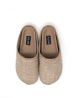 A pair of beige, Roam the Raffia Clog slip-on shoes with a woven exterior, seen from above on a white background. The shoes have the word "ROAM" printed on the insoles and are inspired by the relaxed lifestyle of Scottsdale, Arizona.