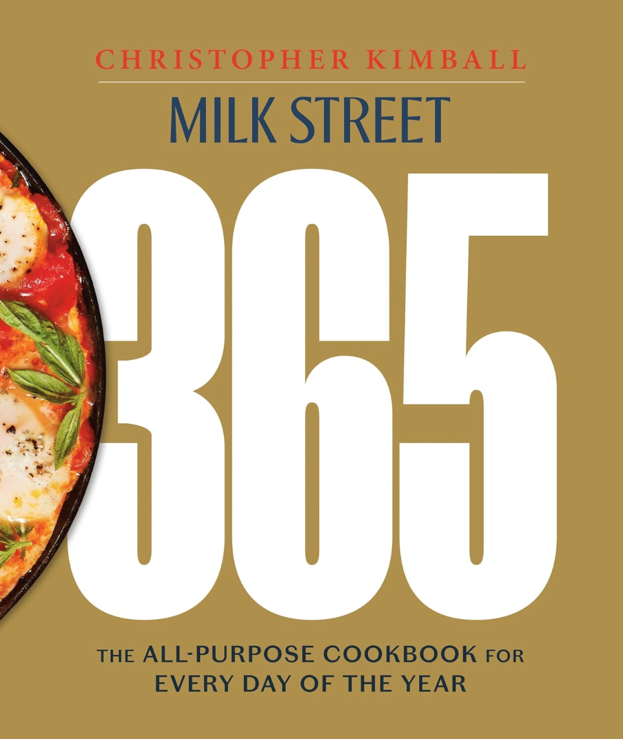 Cover of the "Milk Street 365" cookbook by Hachette Book Group featuring a vibrant image of a skillet with poached eggs and tomatoes, set against a mustard background inspired by Scottsdale Arizona's palette.
