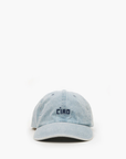 A light blue Clare Vivier denim baseball cap with the word "CIAO" embroidered in black on the front, centered over a white background and designed in Arizona style.
