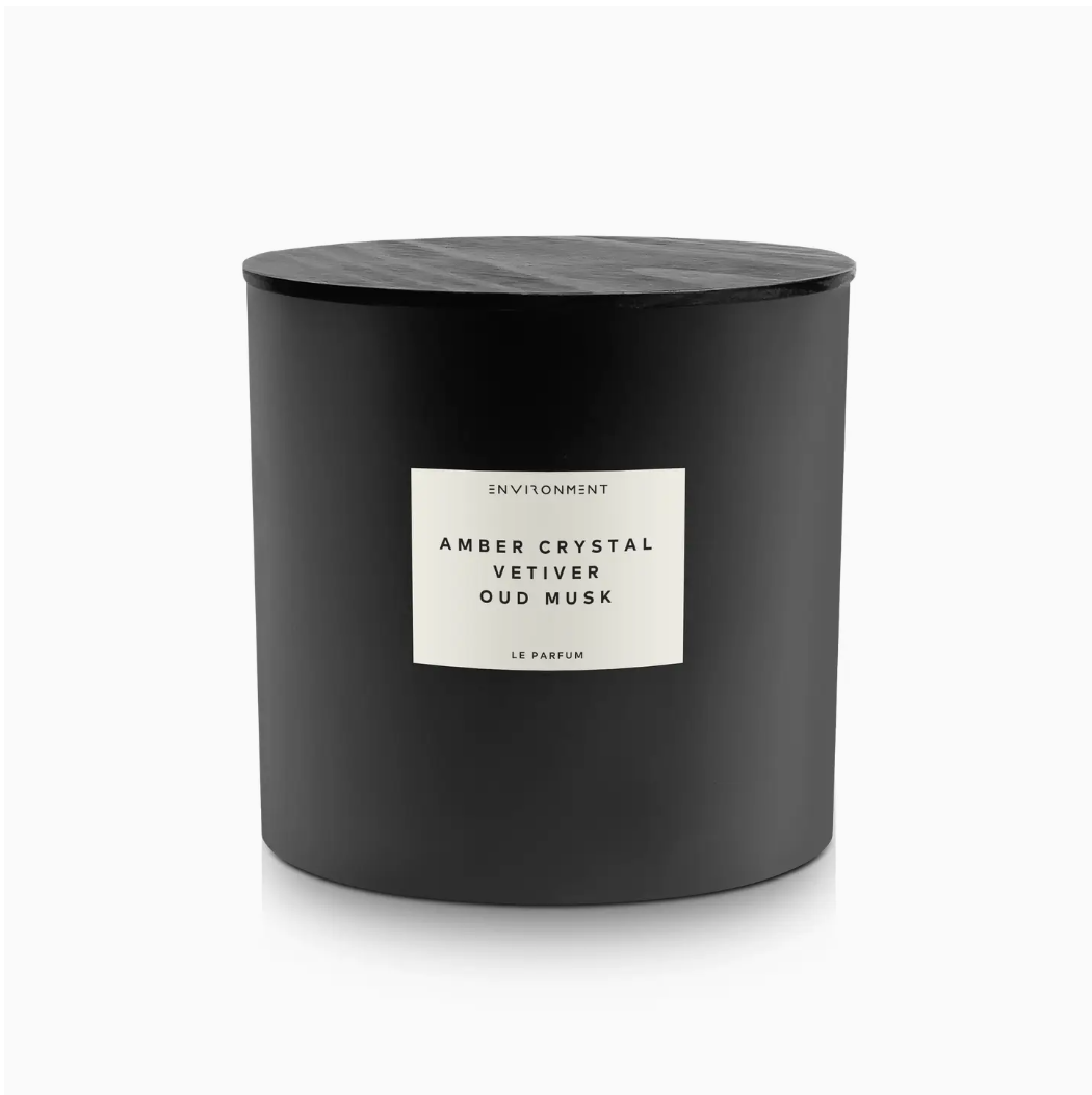 A 55oz Inspired By Baccarat Rouge 540® Candle Amber Crystal with a glossy finish and a black lid, labeled "Amber Crystal Vetiver Oud Musk Le Parfum" on a white minimalist sticker on a plain white background, evocative of a bungalow in Scottsdale, Arizona.