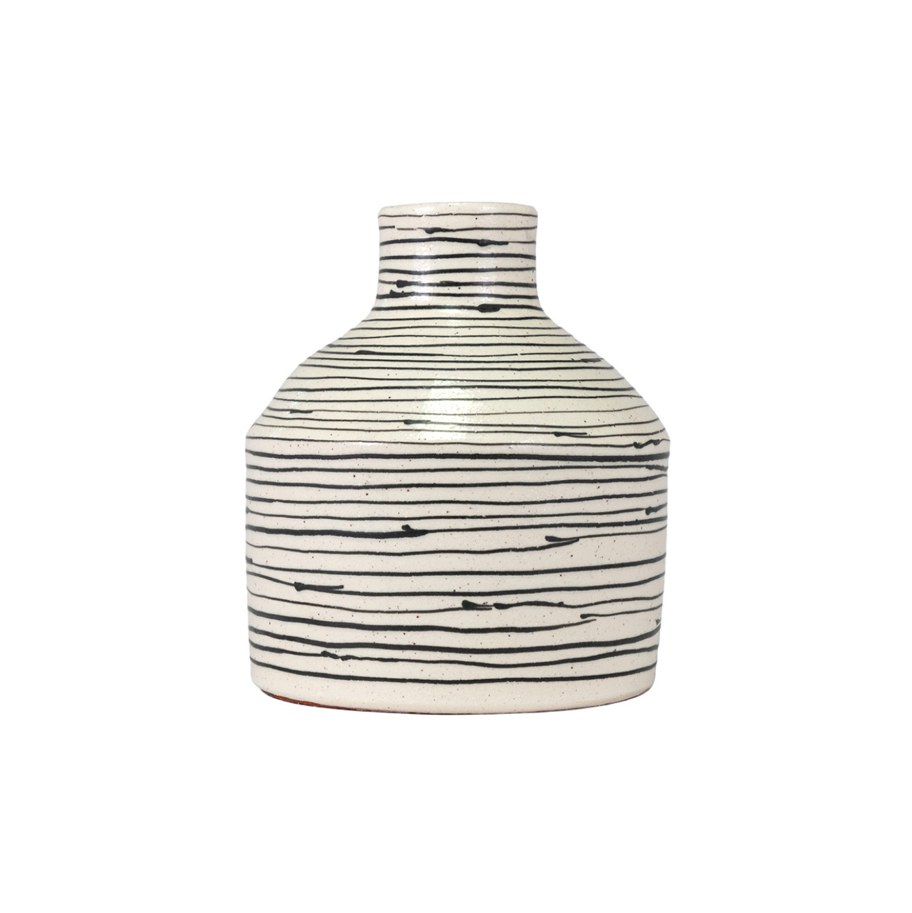 A Isha short vase from The Import Collection features a white base with black horizontal stripes, some lines smeared slightly, against a plain white background in a Scottsdale, Arizona bungalow.