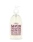 A clear glass pump bottle contains "Liquid Soap 16.7oz" by Cie Luxe Brands, featuring a minimalistic design with dark red text on white. It's labeled "Savon Liquide Marseille Extra Pur, Figue de Provence" and crafted with vegetable oils.