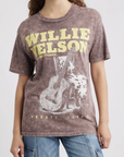 A woman wearing the DayDreamer Willie Nelson Red Headed Stranger graphic t-shirt.