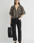 Apiece Apart Nele Lantern Sleeve Top in white, styled with black jeans and loafers, casual modern look.