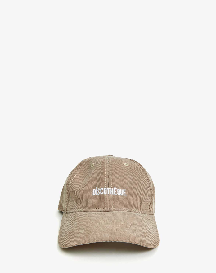 A beige Clare Vivier baseball hat with the word &quot;DISCOTHEQUE&quot; embroidered in a lowercase serif font on the front. The Baseball Hat Stone Corduroy Discothèque, reflecting an Arizona style, is displayed against a plain white background.