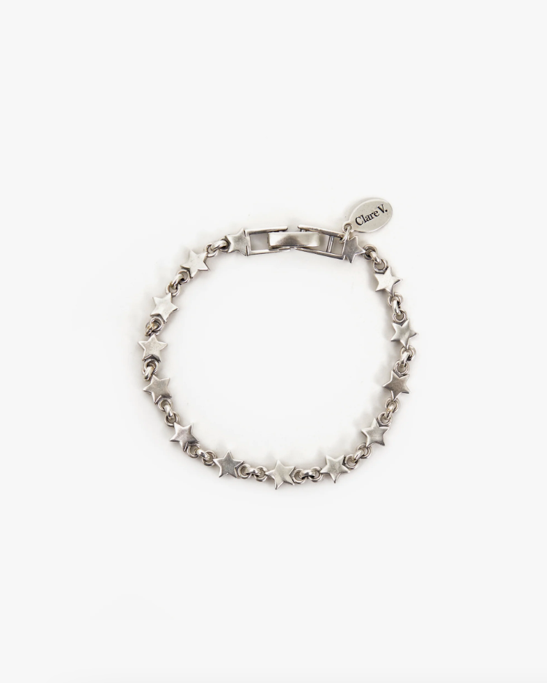 A Star Strand Bracelet Sterling Silver with intricate links and a heart-shaped charm inscribed with &quot;Cheryl&quot; in Arizona style on a white background. (Brand: Clare Vivier)