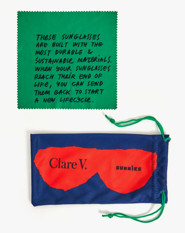 Two colorful pouches for sunglasses; the top one is green with a message about sustainability, and the bottom one in Arizona red style has "Clare V. SUNNIES" printed on it, for Clare V. Heather Sunglasses Cream by Clare Vivier.