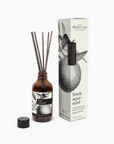 A Faire reed diffuser bottle with sticks and its packaging beside it, labeled "Broken Top Candle Co., citrus scent fragrance oil reed diffuser." The packaging features a black and white citrus fruit illustration.