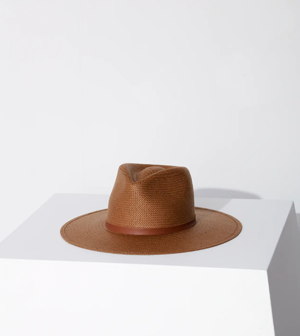 A Janessa Leone Sherman hat brown displayed on a white pedestal against a neutral background, showcasing Arizona style and detail in the design.