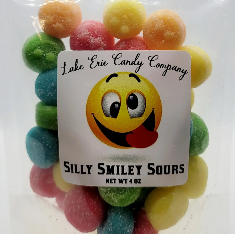 A package of Faire Assorted Easter Jelly Candy featuring a smiling emoji on the label, surrounded by colorful candy balls coated in sugar, purchased from a charming bungalow in Scottsdale, Arizona.