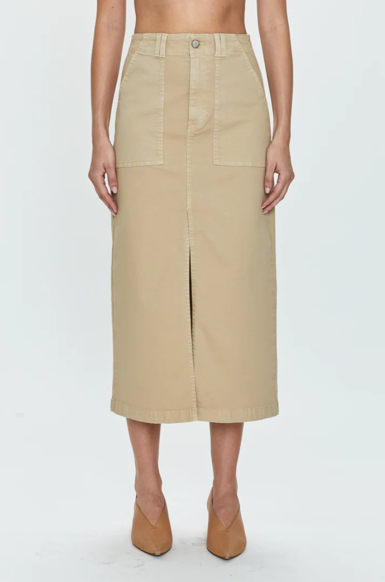 A front view of a Pistola Pamela Skirt High Rise Utility Skirt in a Los Angeles-based style with a button and slit in the center, worn with matching pointed-toe shoes. The image shows the skirt on a person from waist to mid-calf.