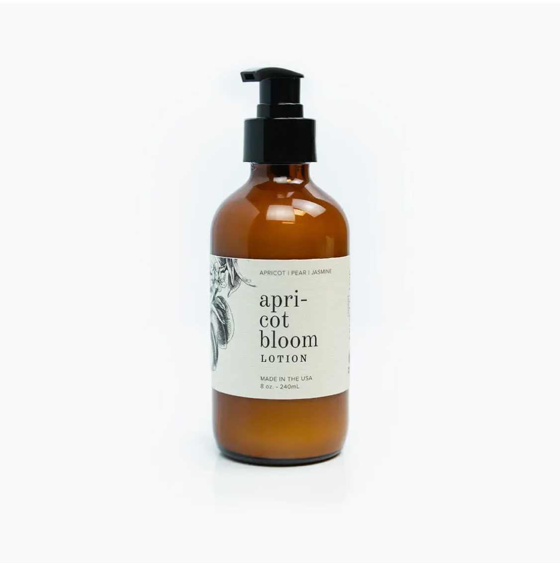 Amber glass bottle with a black pump containing Faire&#39;s &quot;Apricot Bloom Lotion 8 oz.&quot; The label features an artistic floral sketch and text noting the product is made in Arizona. The background is plain white.