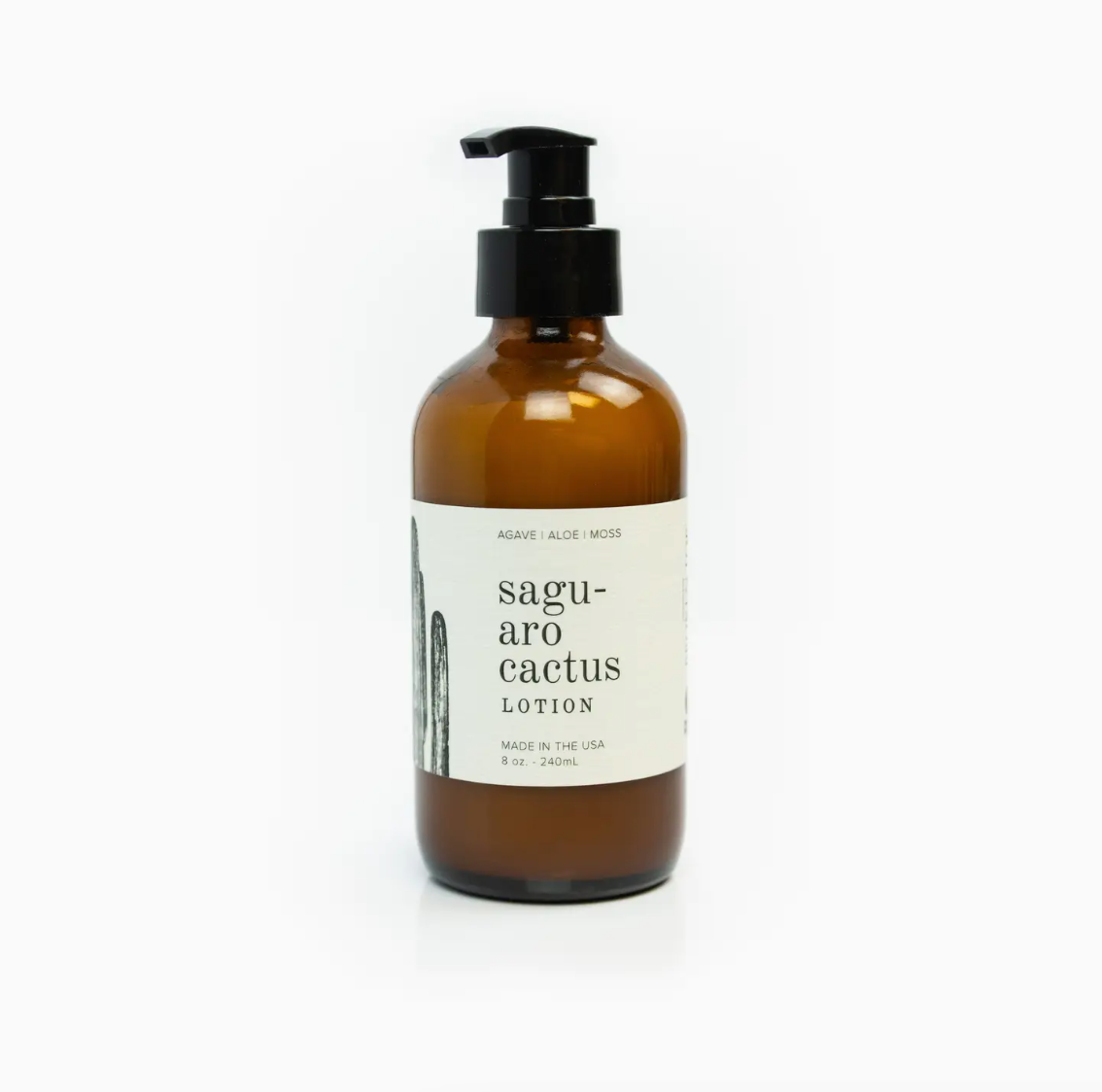 Amber glass bottle with a pump dispenser, labeled &quot;Faire Saguaro Cactus Lotion 8 oz.&quot;, isolated on a white background.