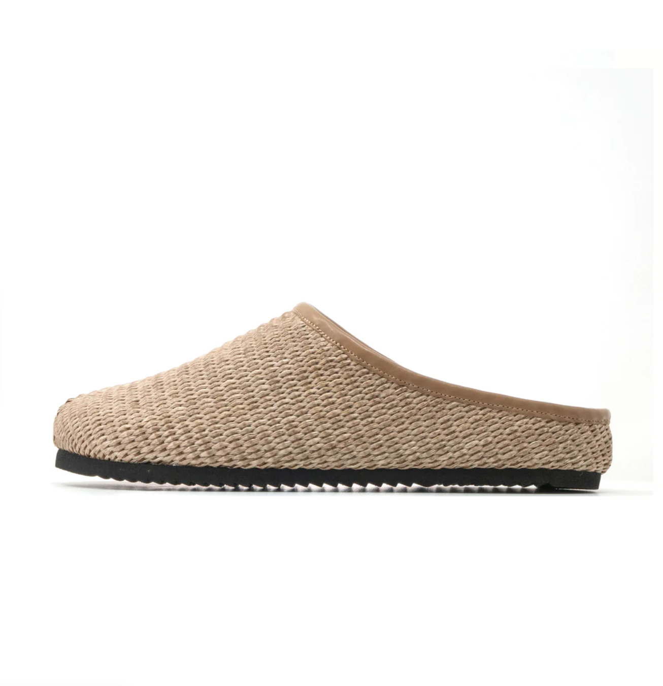 A profile view of a Roam the Raffia Clog slipper with a flat sole, reminiscent of Scottsdale Arizona aesthetics, on a white background.
