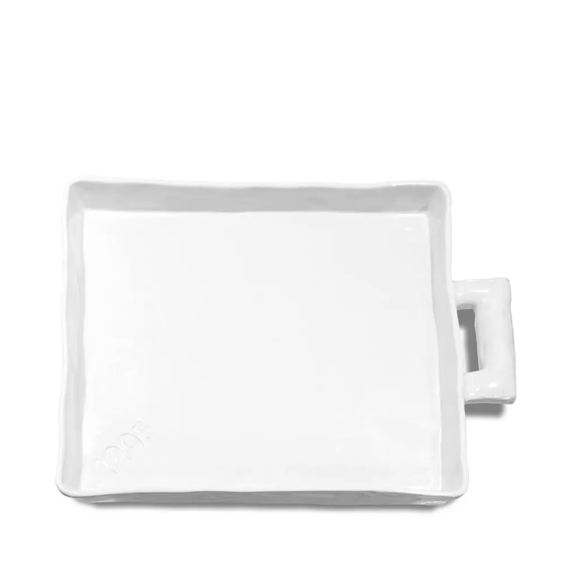 A square, white ceramic plate with a small handle on one side, set against a plain white background. The Montes Doggett Platter No. 454, Large - 1205 has a subtle glossy finish and evokes the minimalist style of a Scottsdale, Arizona bungalow.