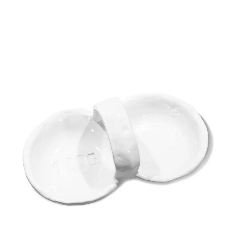 Two white ceramic dishes in Arizona style, one broken in half with the word &quot;YES&quot; visible in the interior of the intact Montes Doggett Appetizer Bowl No. 453 - 1205, set against a plain white background.