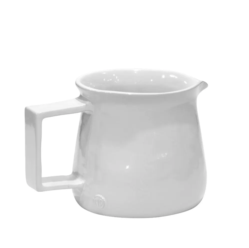A white ceramic Pitcher No. 750 with a handle, pictured against a plain white background typical of a Scottsdale Arizona bungalow. The jug has a glossy finish and a modest pouring spout by Montes Doggett.