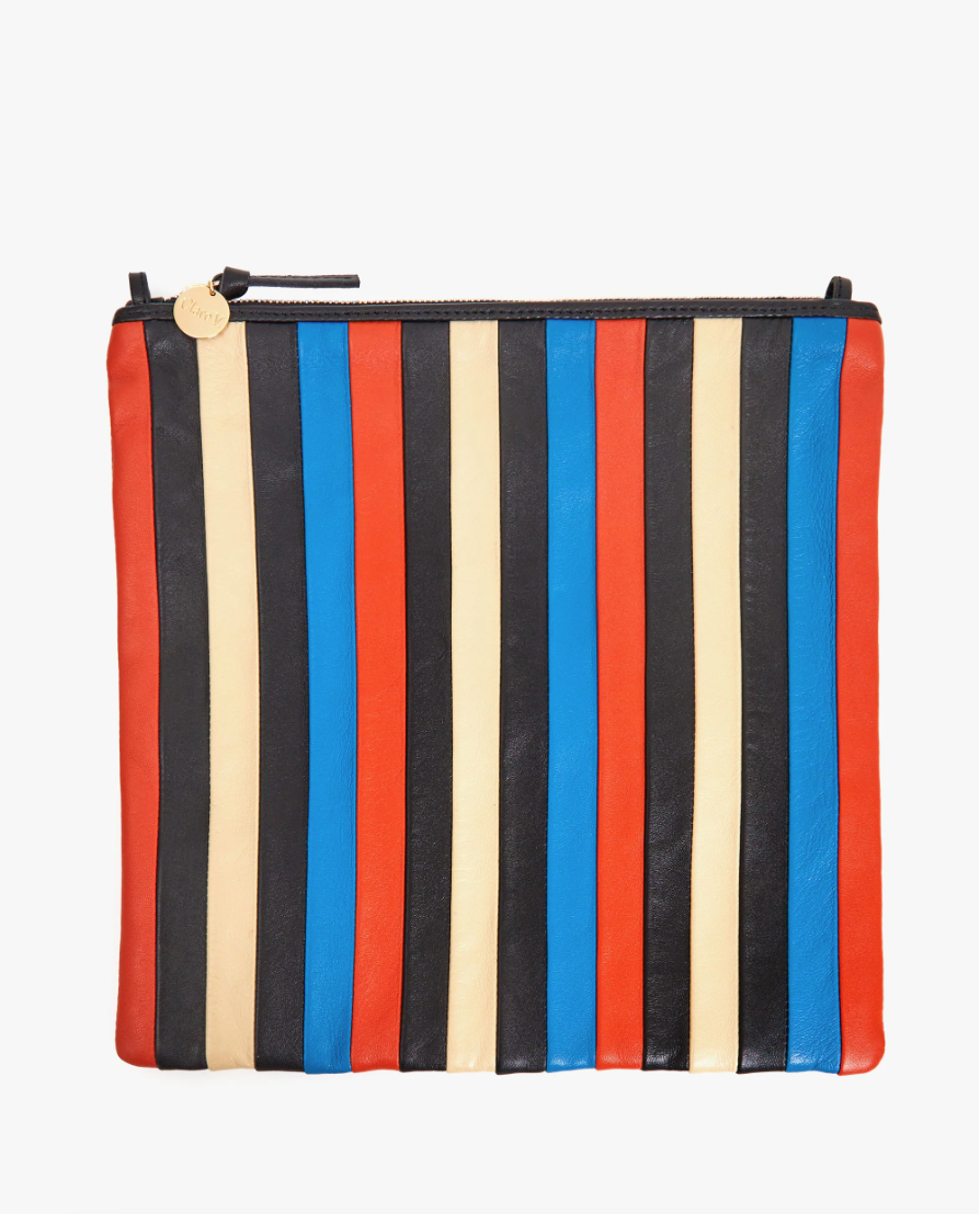A colorful leather pouch featuring vertical stripes in blue, red, and cream, with a zipper on top and a round zipper pull in Clare Vivier style.